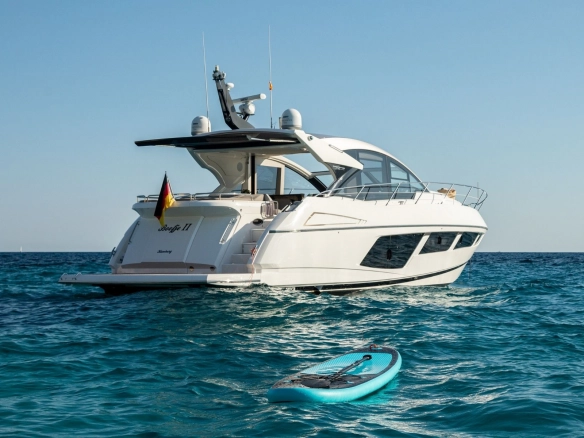 Charter yacht Sunseeker Predator 57 Boefje II at sea with paddle board.