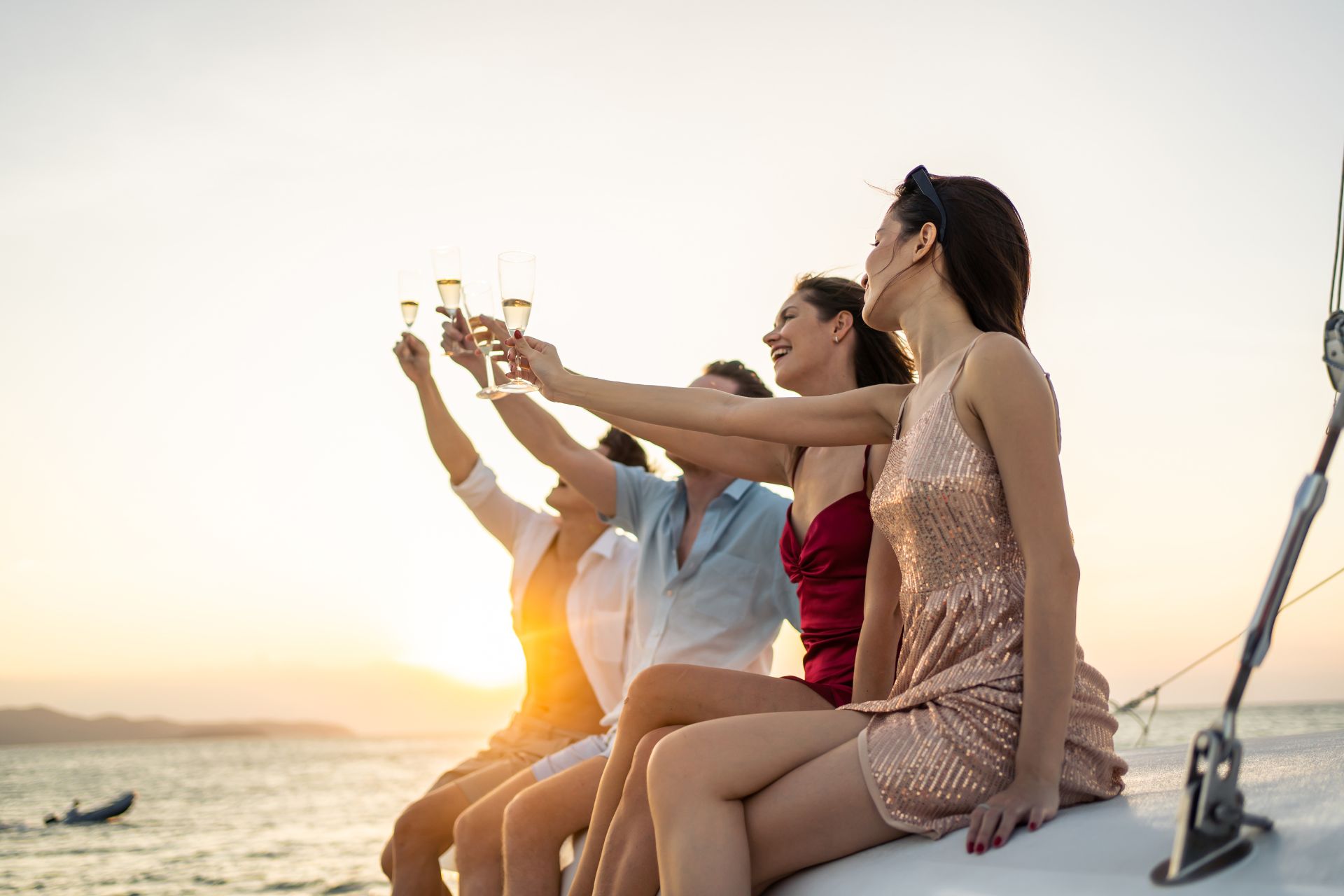 Friends enjoying champagne on a sailing yacht.