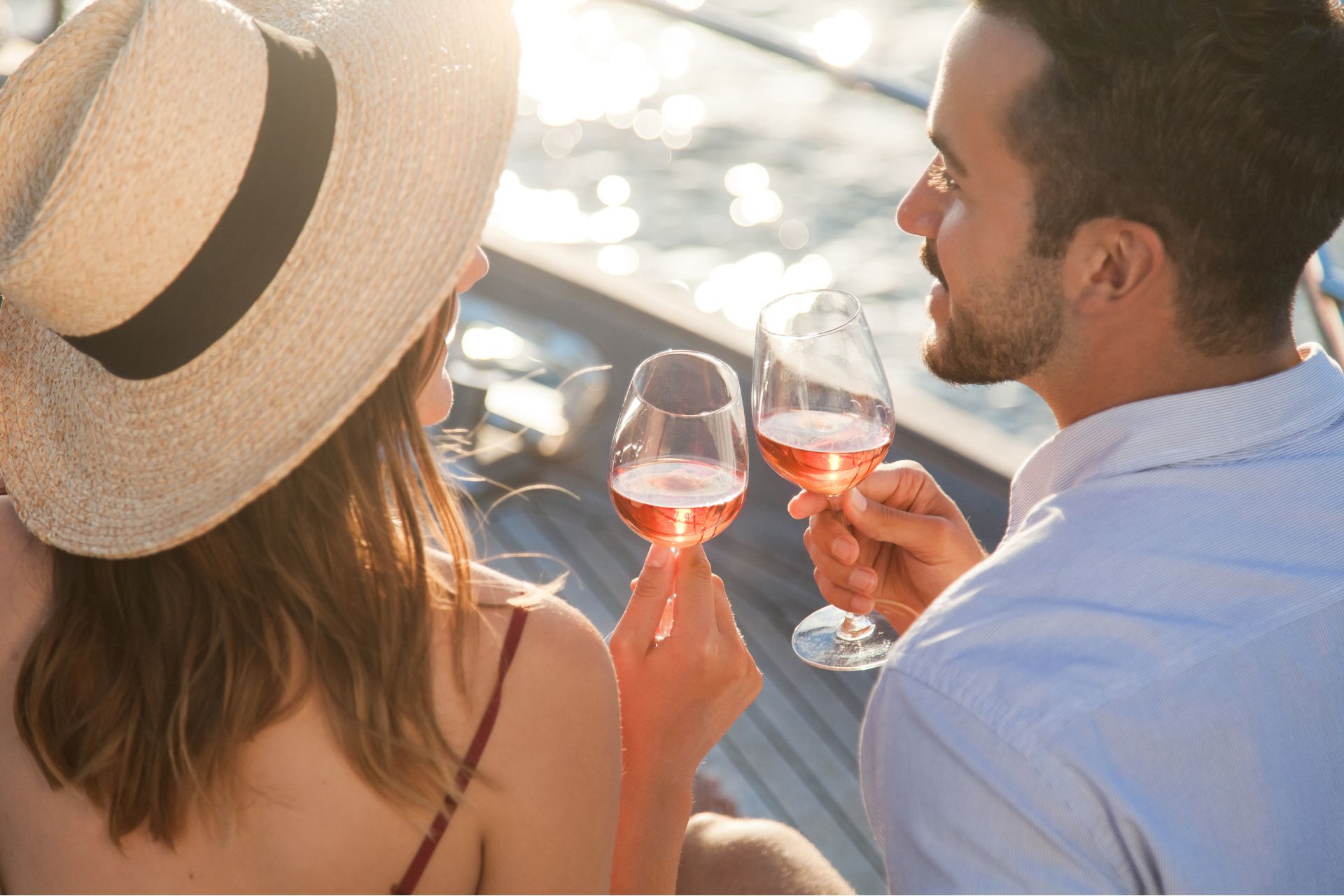 Couple enjoying wine on a yacht at sea.