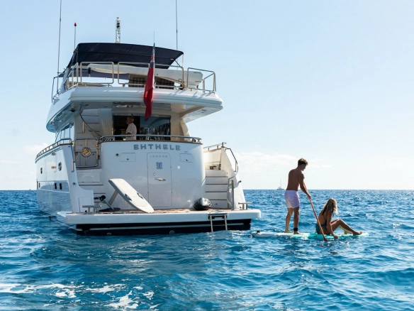 Motor yacht Elegance 78 Ethele with couple on a paddle board in the Mediterranean.