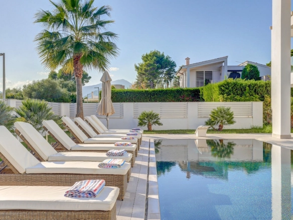 Pool and exterior lounge area of property Pollensa Sea View in Mallorca.