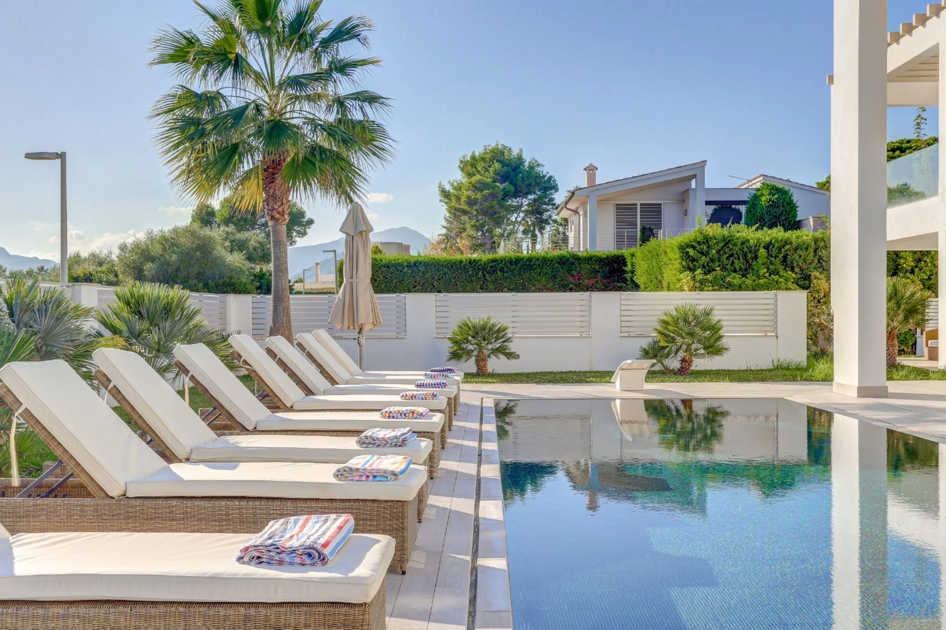 Pool and exterior lounge area of property Pollensa Sea View in Mallorca.