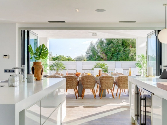 Kitchen and exterior dining area of property Pollensa Sea View in Mallorca.