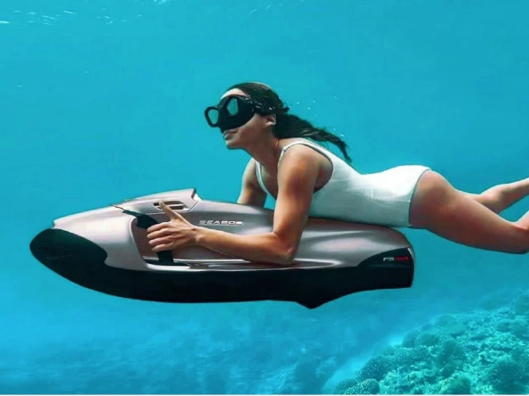 Woman riding a Seabob underwater.