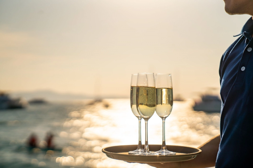 Yacht crew serving drinks.