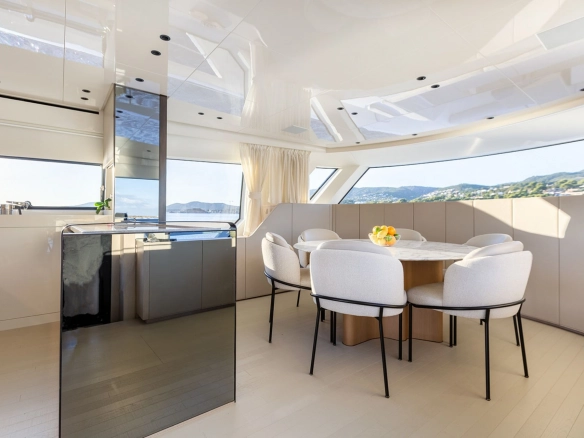Dining area and galley of charter yacht Sanlorenzo SX76 Cloud IX in Mallorca.