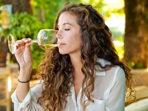 Woman with glas of white wine.