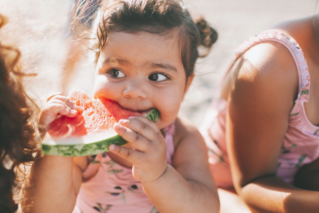 Child eating watermelon.