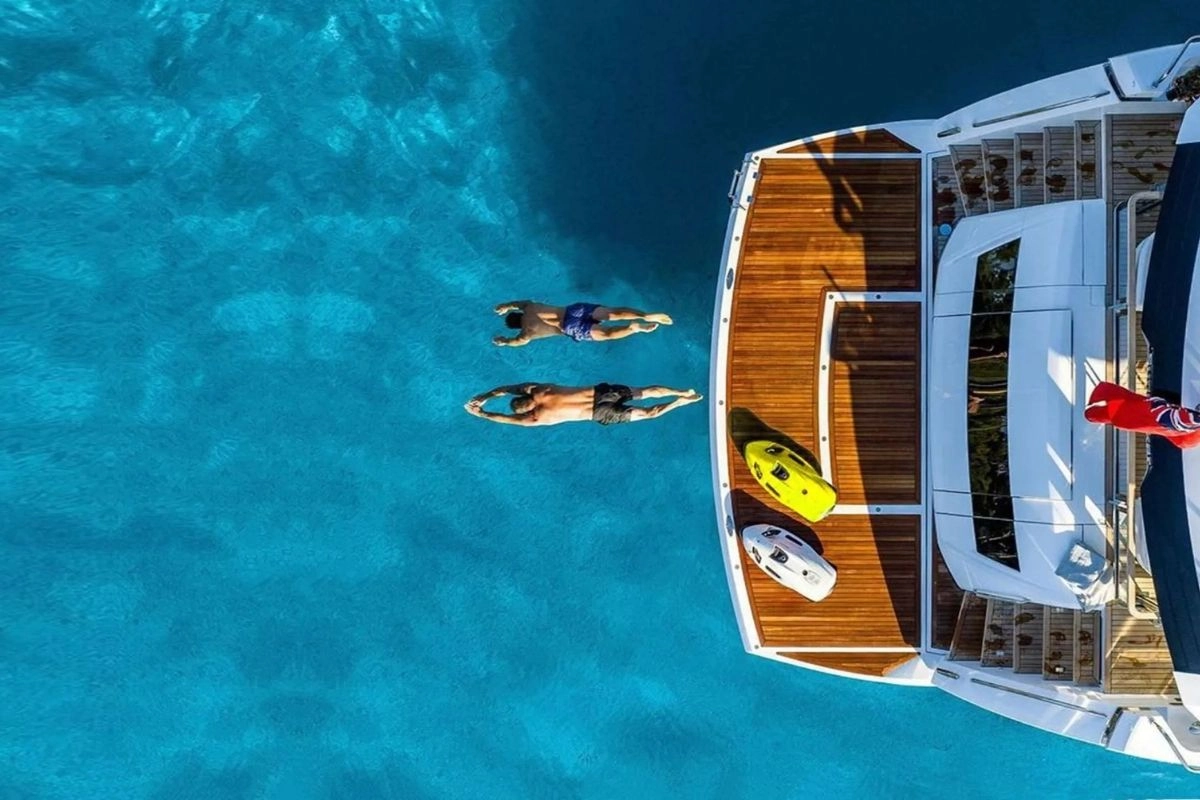 Friends on a yacht with water toys