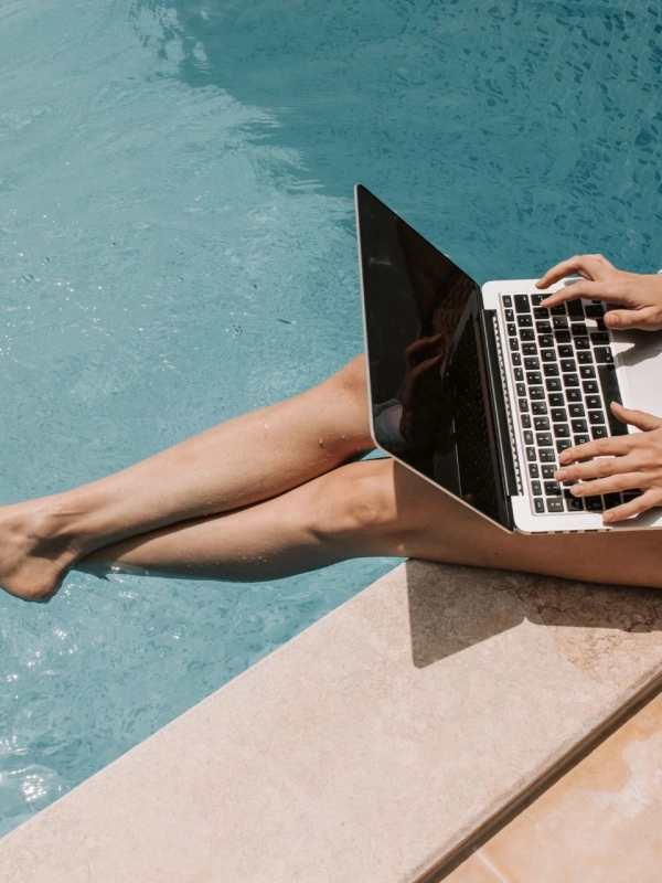 pool-laptop Woman with laptop next to pool.